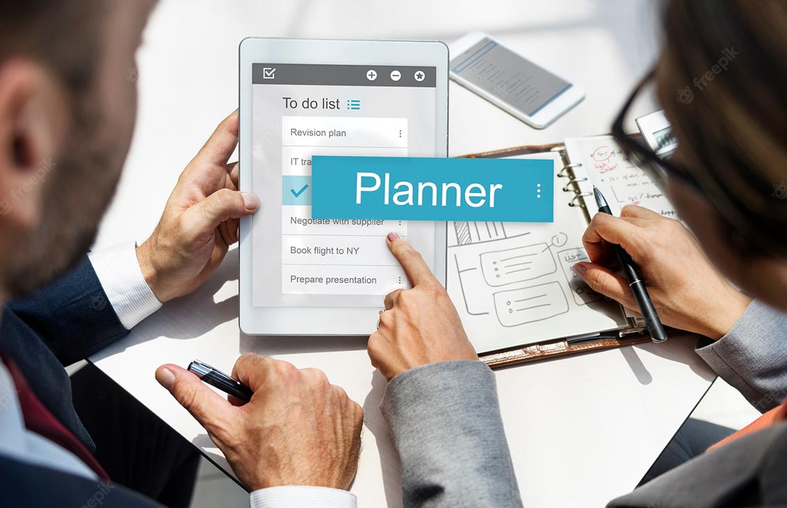 Photo of a professional man and woman looking at a tablet with the word Planner over the photo