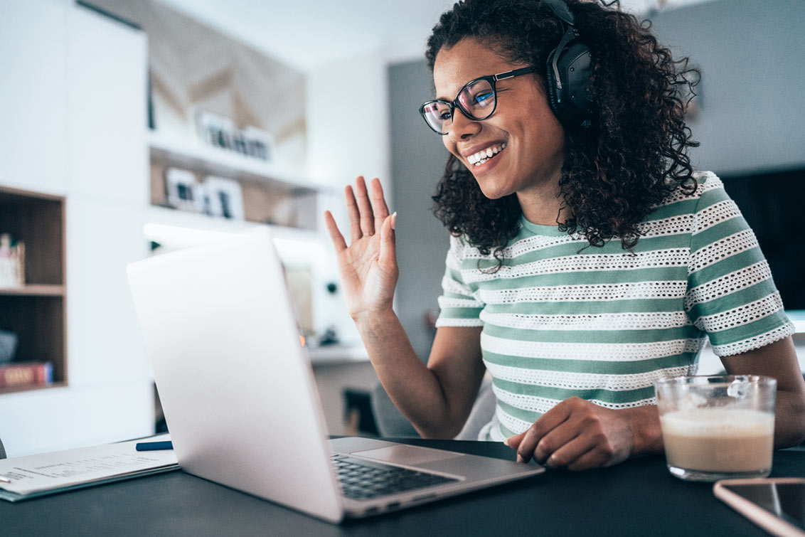 Young modern woman having Video Conference at home